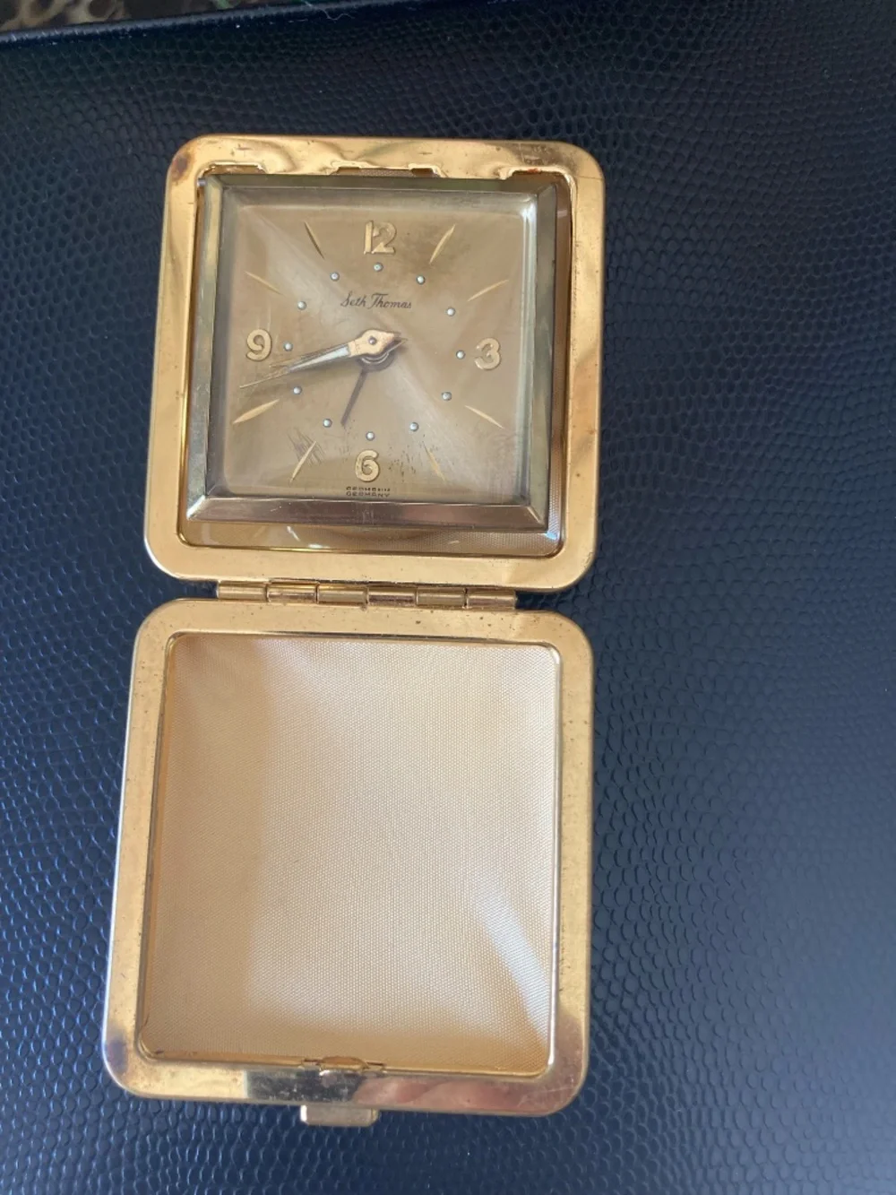 Classic mid-century Seth Thomas folding travel alarm clock in gold-tone texture